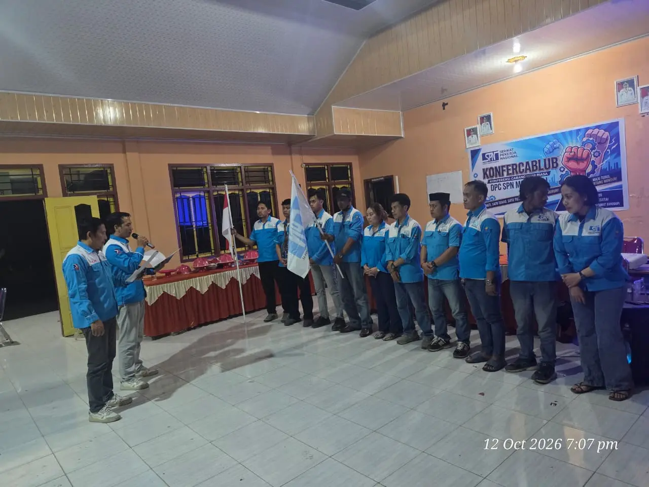 Pengurus DPC SPN Morowali berbaris saat pelantikan dengan bendera merah putih dan bendera SPN